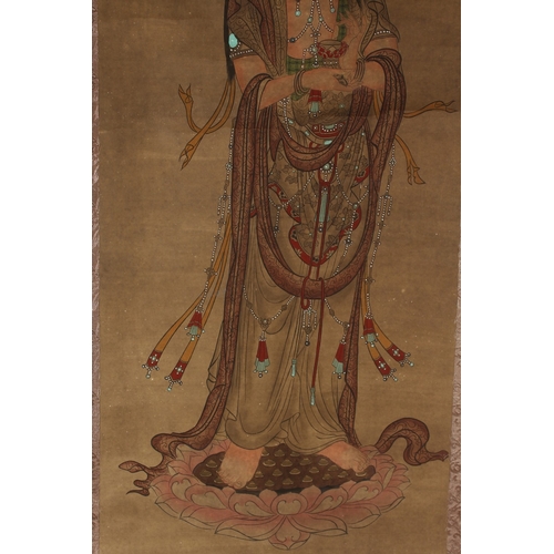 245 - A CHINESE SCROLL PAINTING ON PAPER, depicting Guanyin stood upon a lotus.