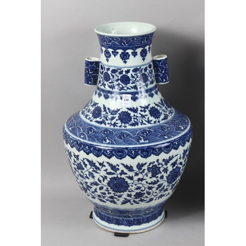 248 - A VERY LARGE PAIR OF CHINESE BLUE AND WHITE PORCELAIN TWIN HANDLE FLORAL VASES, each with character ... 