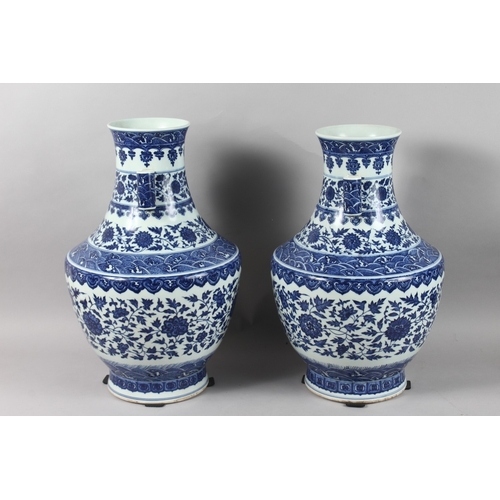 248 - A VERY LARGE PAIR OF CHINESE BLUE AND WHITE PORCELAIN TWIN HANDLE FLORAL VASES, each with character ... 