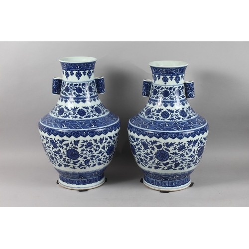 248 - A VERY LARGE PAIR OF CHINESE BLUE AND WHITE PORCELAIN TWIN HANDLE FLORAL VASES, each with character ... 