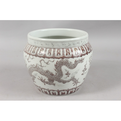 253 - A CHINESE UNDERGLAZE RED AND WHITE PORCELAIN DRAGON JARDINIERE, 19cm high.