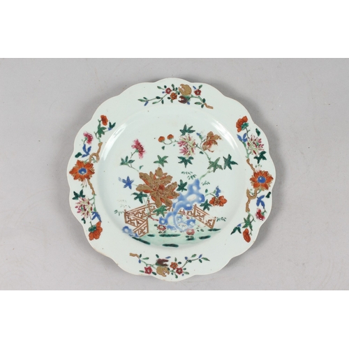 264 - A FINE CHINESE POLYCHROME PORCELAIN SCALLOPED PLATE, with painted enamels depicting flora with gilt ... 