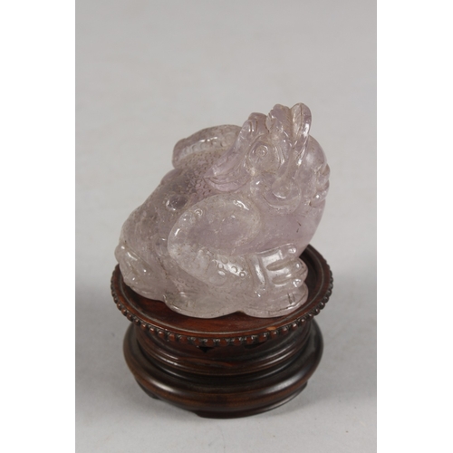 273 - A CHINESE CARVED ROSE QUARTZ TOAD ON HARDWOOD STAND, rose quartz 6.5cm high, 7cm long.