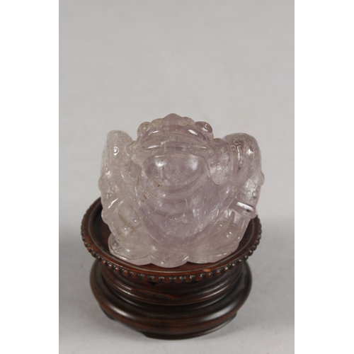 273 - A CHINESE CARVED ROSE QUARTZ TOAD ON HARDWOOD STAND, rose quartz 6.5cm high, 7cm long.