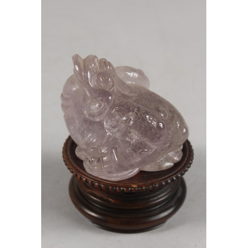 273 - A CHINESE CARVED ROSE QUARTZ TOAD ON HARDWOOD STAND, rose quartz 6.5cm high, 7cm long.