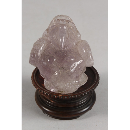 273 - A CHINESE CARVED ROSE QUARTZ TOAD ON HARDWOOD STAND, rose quartz 6.5cm high, 7cm long.