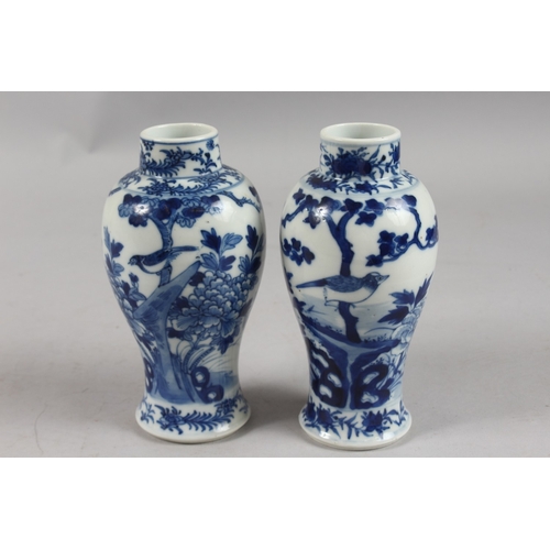 278 - A PAIR OF CHINESE BLUE AND WHITE PORCELAIN VASES, painted with birds, trees, and flora, 18cm high.