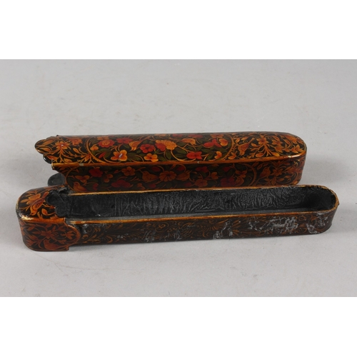 283 - A FINE PERSIAN QAJAR LACQUERED PAPIER MACHE PENBOX, 23cm long.