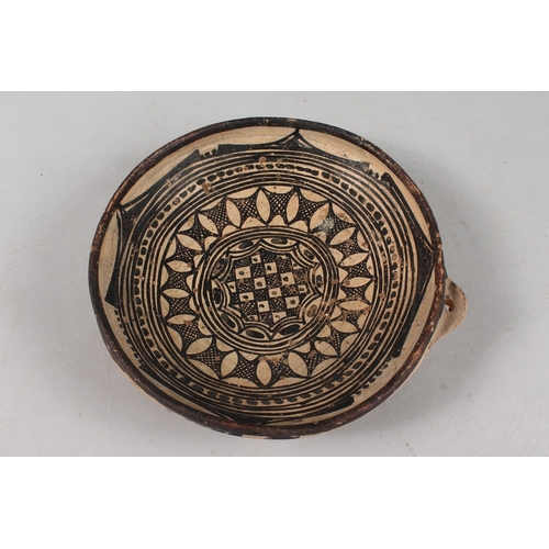 284 - A 19TH CENTURY NORTH AFRICAN PROBABLY ALGERIAN POTTERY DISH, 21cm diameter.