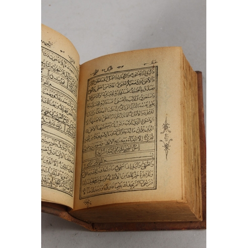 286 - A FINE 19TH CENTURY POSSIBLY PERSIAN LEATHER BOUND SMALL QURAN, signed and dated, 1308 HD / 1890 AD,... 