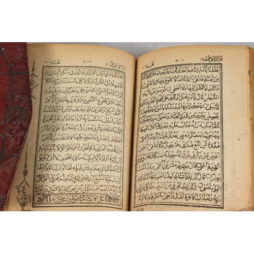 286 - A FINE 19TH CENTURY POSSIBLY PERSIAN LEATHER BOUND SMALL QURAN, signed and dated, 1308 HD / 1890 AD,... 