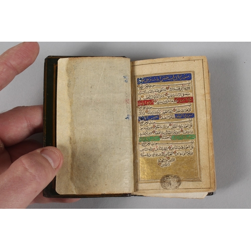 294 - A VERY FINE 19TH CENTURY PERSIAN QAJAR POCKET QURAN, with finely lacquered floral cover, the interio... 