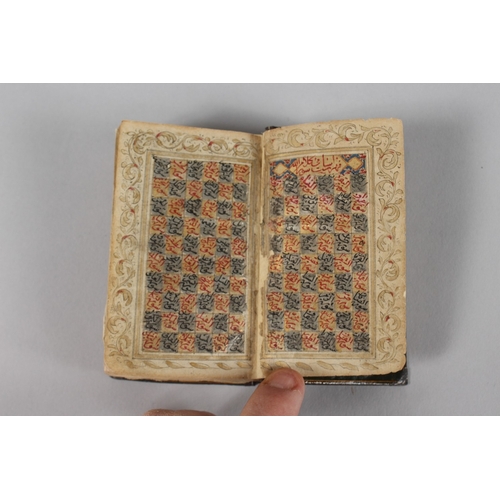 294 - A VERY FINE 19TH CENTURY PERSIAN QAJAR POCKET QURAN, with finely lacquered floral cover, the interio... 