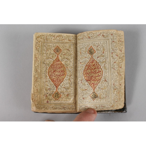 294 - A VERY FINE 19TH CENTURY PERSIAN QAJAR POCKET QURAN, with finely lacquered floral cover, the interio... 