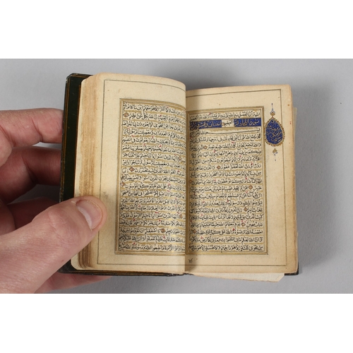 294 - A VERY FINE 19TH CENTURY PERSIAN QAJAR POCKET QURAN, with finely lacquered floral cover, the interio... 