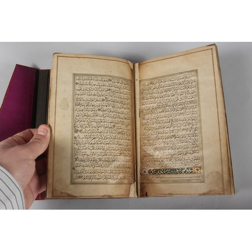 296 - A FINE PERSIAN QAJAR LEATHER BOUND QURAN, with embossed cover and finely gilded illuminated pages, d... 