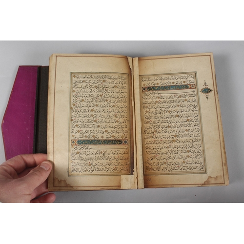 296 - A FINE PERSIAN QAJAR LEATHER BOUND QURAN, with embossed cover and finely gilded illuminated pages, d... 