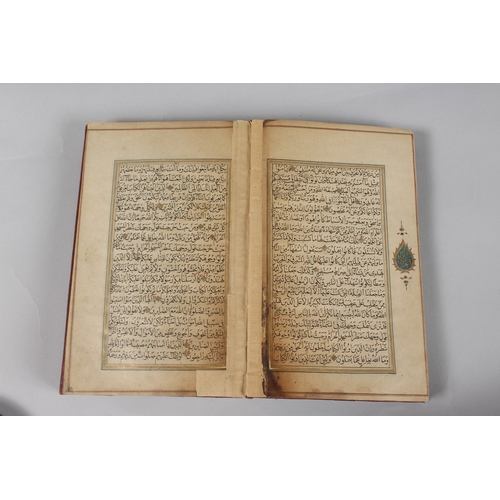 296 - A FINE PERSIAN QAJAR LEATHER BOUND QURAN, with embossed cover and finely gilded illuminated pages, d... 