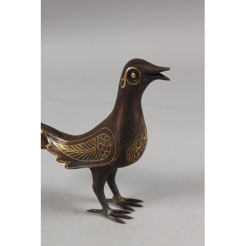 299 - A PERSIAN QAJAR GOLD INLAID STEEL BIRD, 15.5cm high.