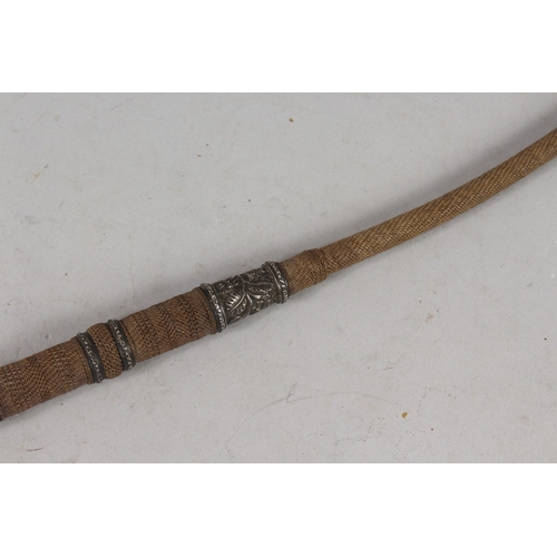 301 - A 19TH CENTURY INDIAN WHIP, mounted with engraved silver bands, 52cm long.