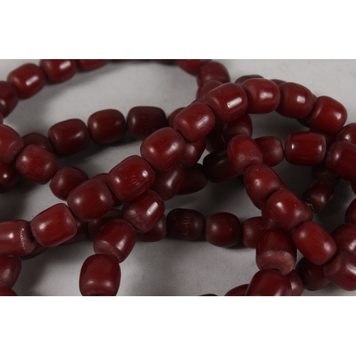 307 - A SET OF RED BEAD - POSSIBLY BAKELITE OR CHERRY AMBER PRAYER BEADS.