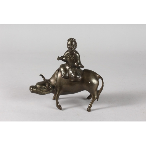 31 - A CHINESE BRONZE INCENSE BURNER FORMED AS A BOY AND WATER BUFFALO, 15cm long.