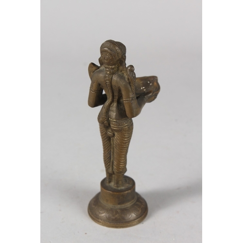 33 - AN INDIAN BRONZE DEITY FIGURAL OIL LAMP, 15cm high.