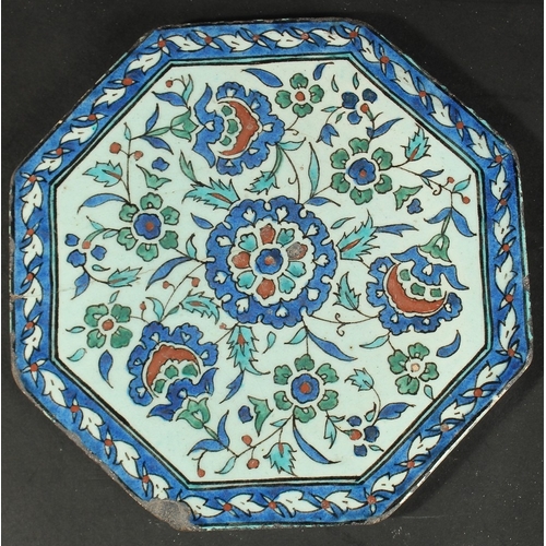 371 - AN ISLAMIC MARKET FRENCH OR ITALIAN GLAZED POTTERY OCTAGONAL TILE, painted with floral motifs, 23cm ... 