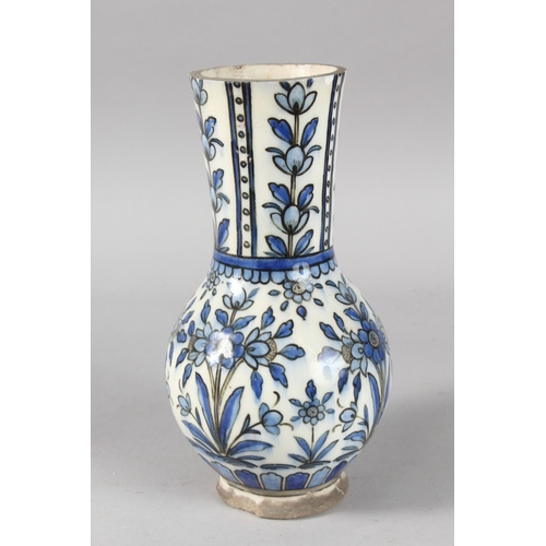 38 - A 19TH CENTURY PERSIAN BLUE AND WHITE GLAZED POTTERY VASE, painted with floral motifs, 27cm high.