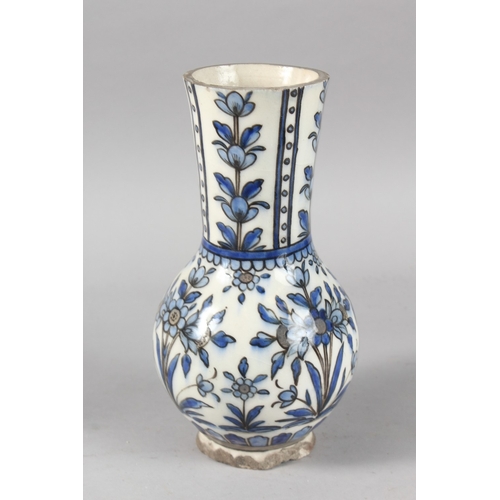 38 - A 19TH CENTURY PERSIAN BLUE AND WHITE GLAZED POTTERY VASE, painted with floral motifs, 27cm high.