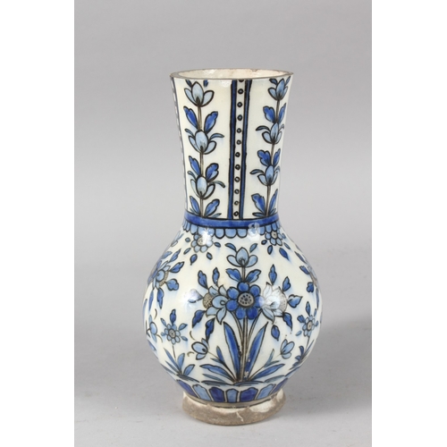 38 - A 19TH CENTURY PERSIAN BLUE AND WHITE GLAZED POTTERY VASE, painted with floral motifs, 27cm high.