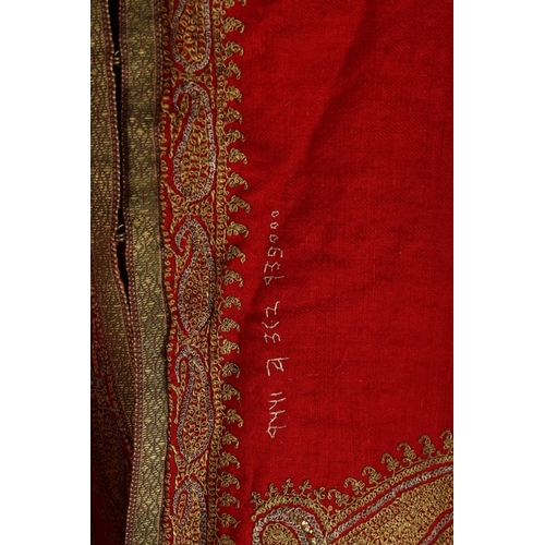 389 - AN INDIAN KASHMIR EMBROIDERED DRESS COAT, with paisley designs and quilted satin lining, bearing sti... 