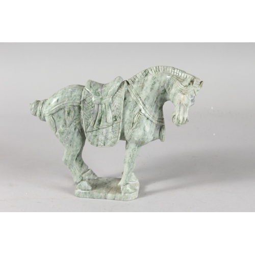 39 - A CARVED GREEN HARDSTONE FIGURE OF A HORSE, 17cm high, 21cm long.