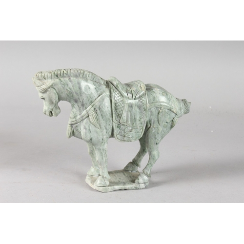 39 - A CARVED GREEN HARDSTONE FIGURE OF A HORSE, 17cm high, 21cm long.