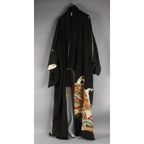 390 - A JAPANESE EMBROIDERED BLACK SILK ROBE, with various gilt and floral designs to lower section.