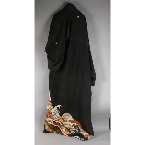 390 - A JAPANESE EMBROIDERED BLACK SILK ROBE, with various gilt and floral designs to lower section.