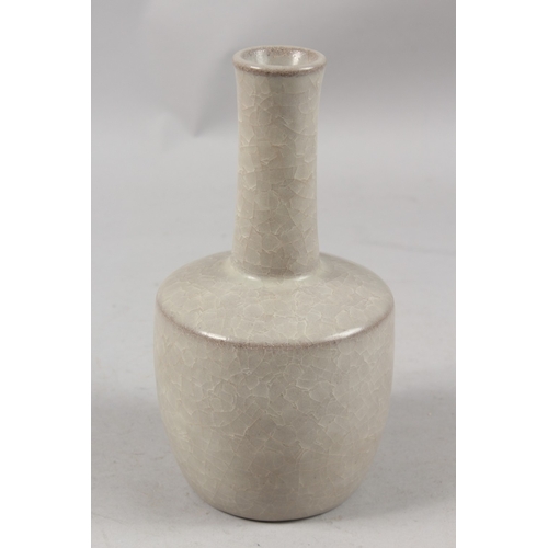 404 - A CHINESE CRACKLE GLAZE POTTERY BOTTLE VASE, 22cm high.