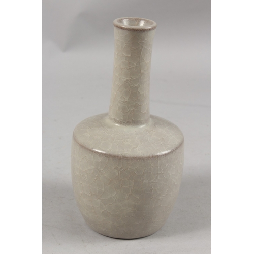 404 - A CHINESE CRACKLE GLAZE POTTERY BOTTLE VASE, 22cm high.