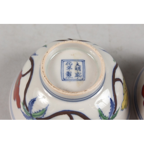 407 - A PAIR OF CHINESE DOUCAI PORCELAIN TEA BOWLS, with floral decoration, each base with six-character m... 