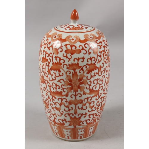 413 - A CHINESE CORAL RED AND WHITE PORCELAIN TALL GINGER JAR AND COVER, 26cm high.