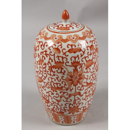 413 - A CHINESE CORAL RED AND WHITE PORCELAIN TALL GINGER JAR AND COVER, 26cm high.