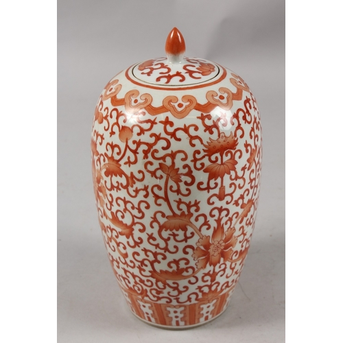 413 - A CHINESE CORAL RED AND WHITE PORCELAIN TALL GINGER JAR AND COVER, 26cm high.