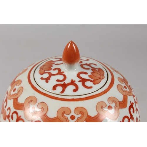 413 - A CHINESE CORAL RED AND WHITE PORCELAIN TALL GINGER JAR AND COVER, 26cm high.