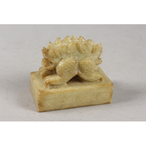 416 - A CHINESE CARVED GREEN SOAPSTONE SEAL, formed as a two-headed beast, 8cm long.