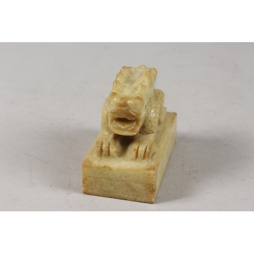 416 - A CHINESE CARVED GREEN SOAPSTONE SEAL, formed as a two-headed beast, 8cm long.