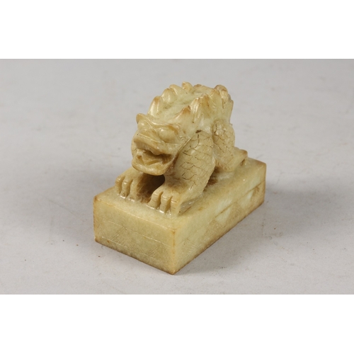 416 - A CHINESE CARVED GREEN SOAPSTONE SEAL, formed as a two-headed beast, 8cm long.