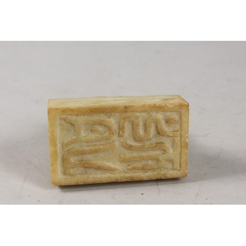 416 - A CHINESE CARVED GREEN SOAPSTONE SEAL, formed as a two-headed beast, 8cm long.