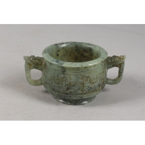 417 - A FINE CHINESE CARVED JADE TWIN HANDLE CENSER, with archaic designs, applied collection sticker to b... 