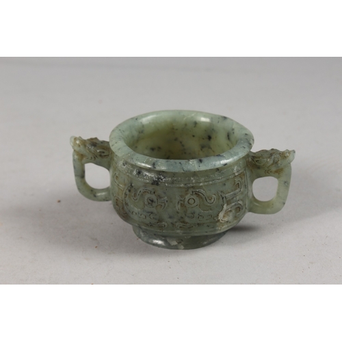 417 - A FINE CHINESE CARVED JADE TWIN HANDLE CENSER, with archaic designs, applied collection sticker to b... 