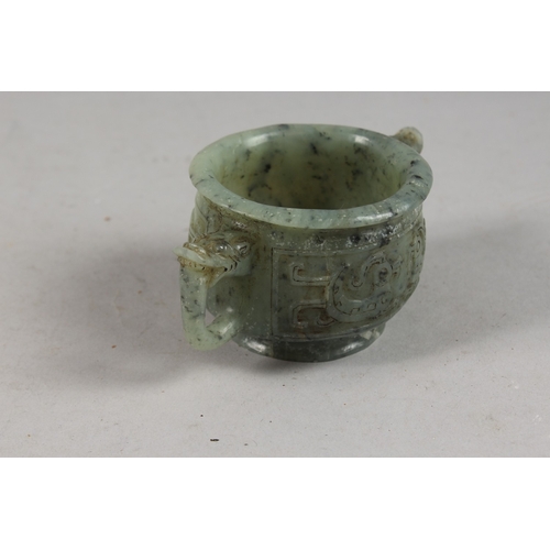 417 - A FINE CHINESE CARVED JADE TWIN HANDLE CENSER, with archaic designs, applied collection sticker to b... 